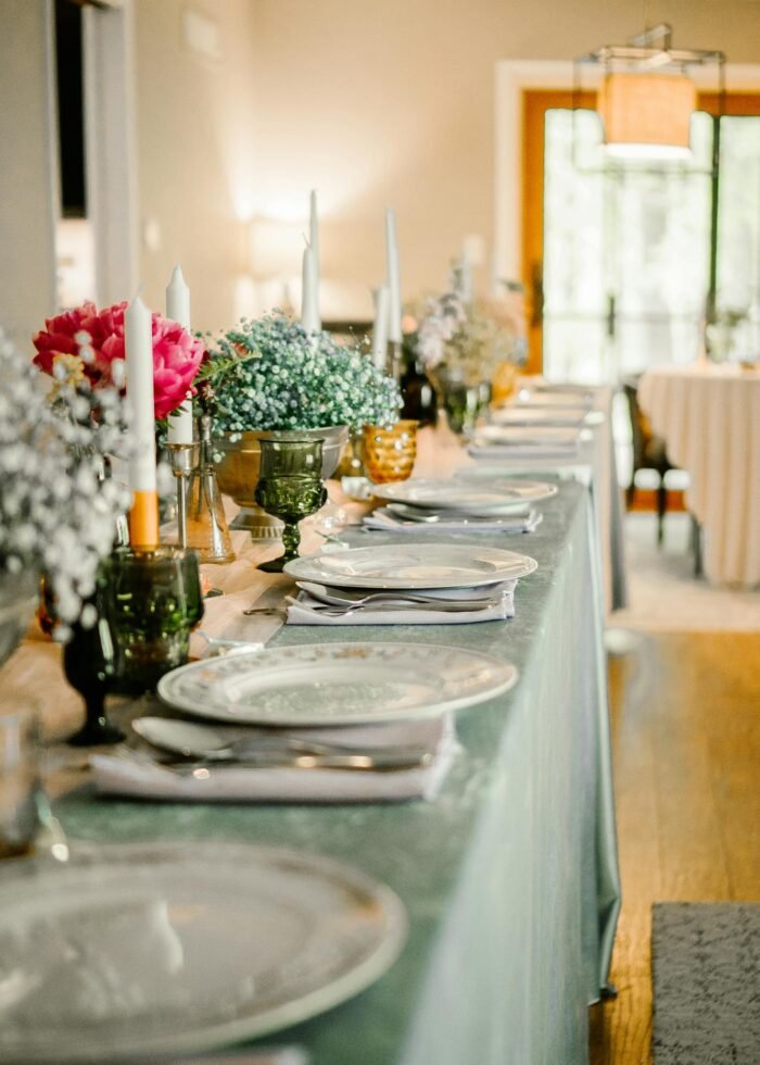 A long table with plates and glasses on it