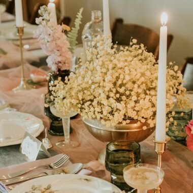 A table with candles and flowers on it