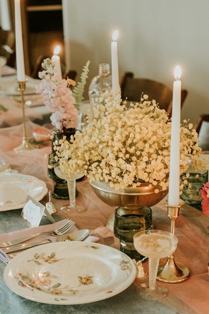 A table with candles and flowers on it